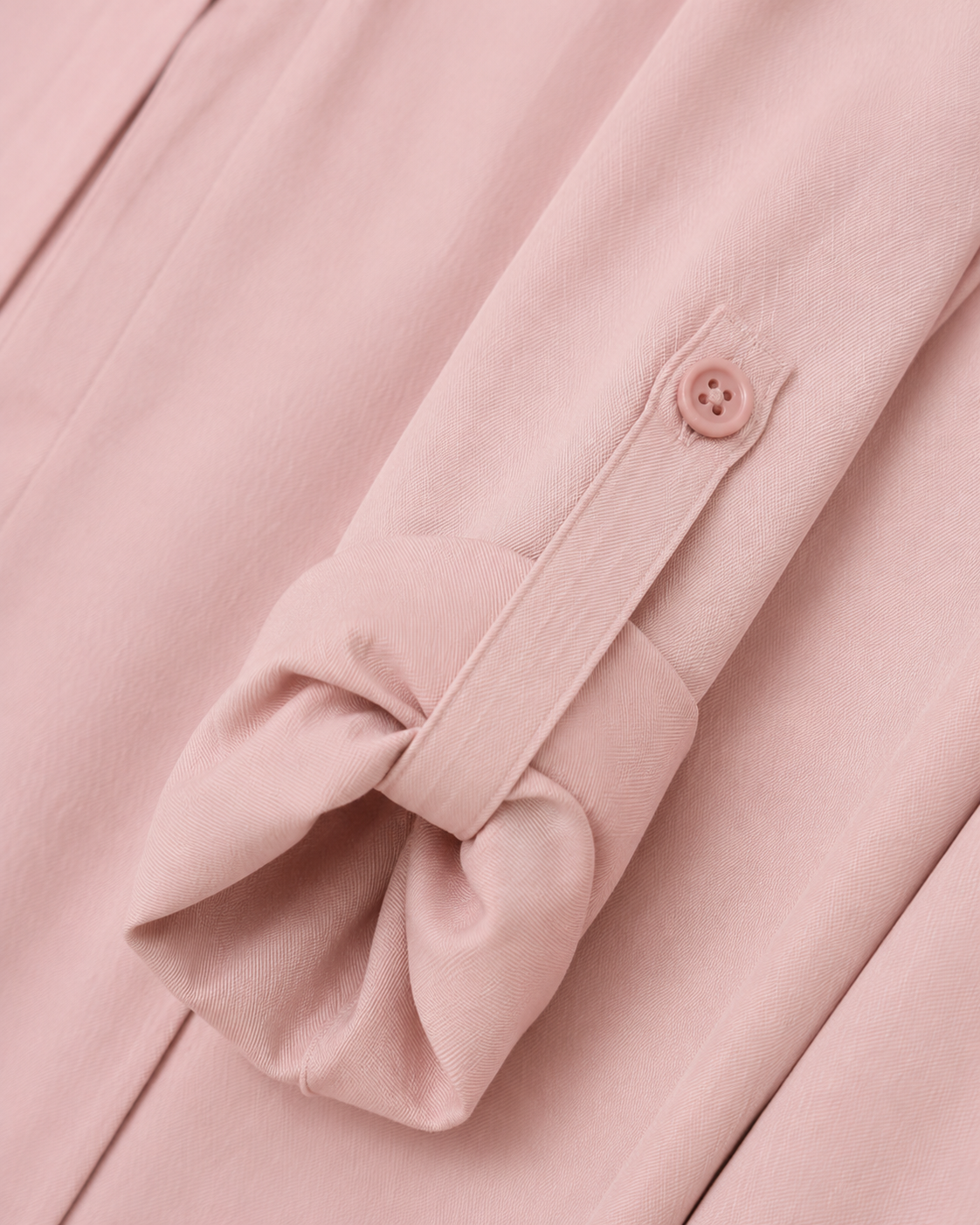 Shelby Twill Light Pink rolled sleeve tab fastened to its button